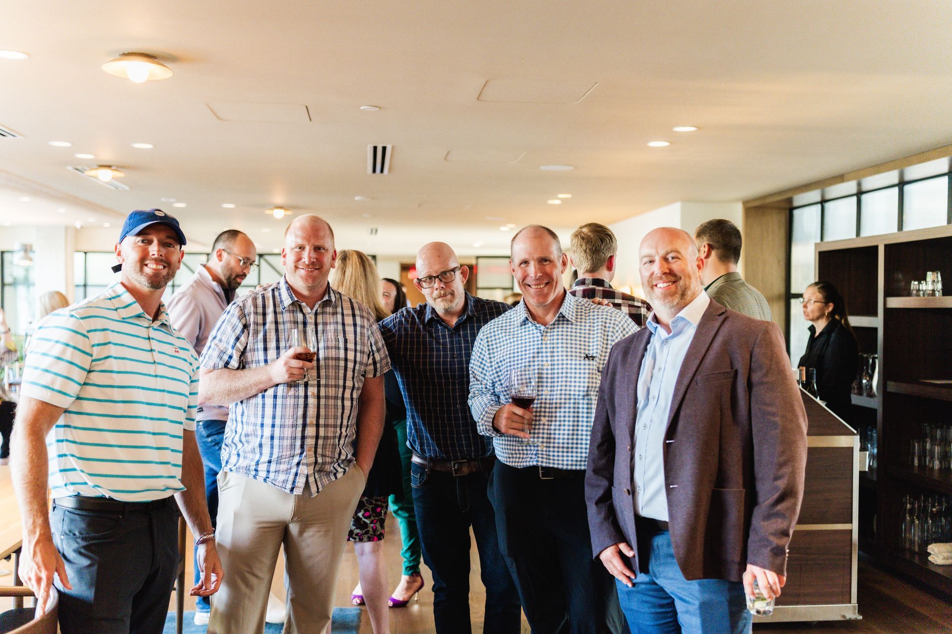 A group of men are standing next to each other in a room.