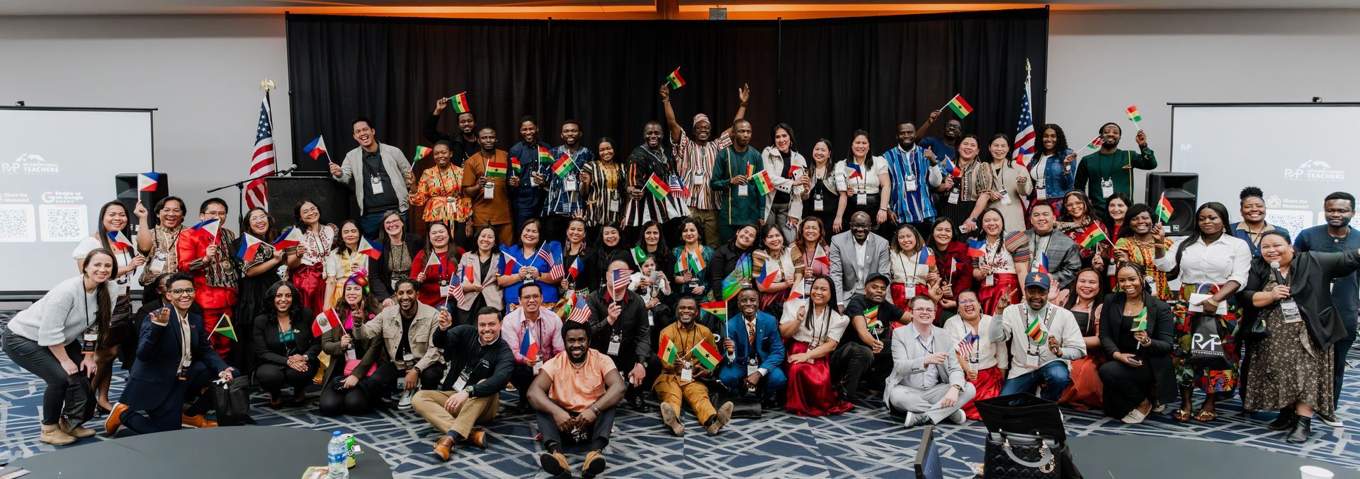 A large group of people are posing for a picture in a room.