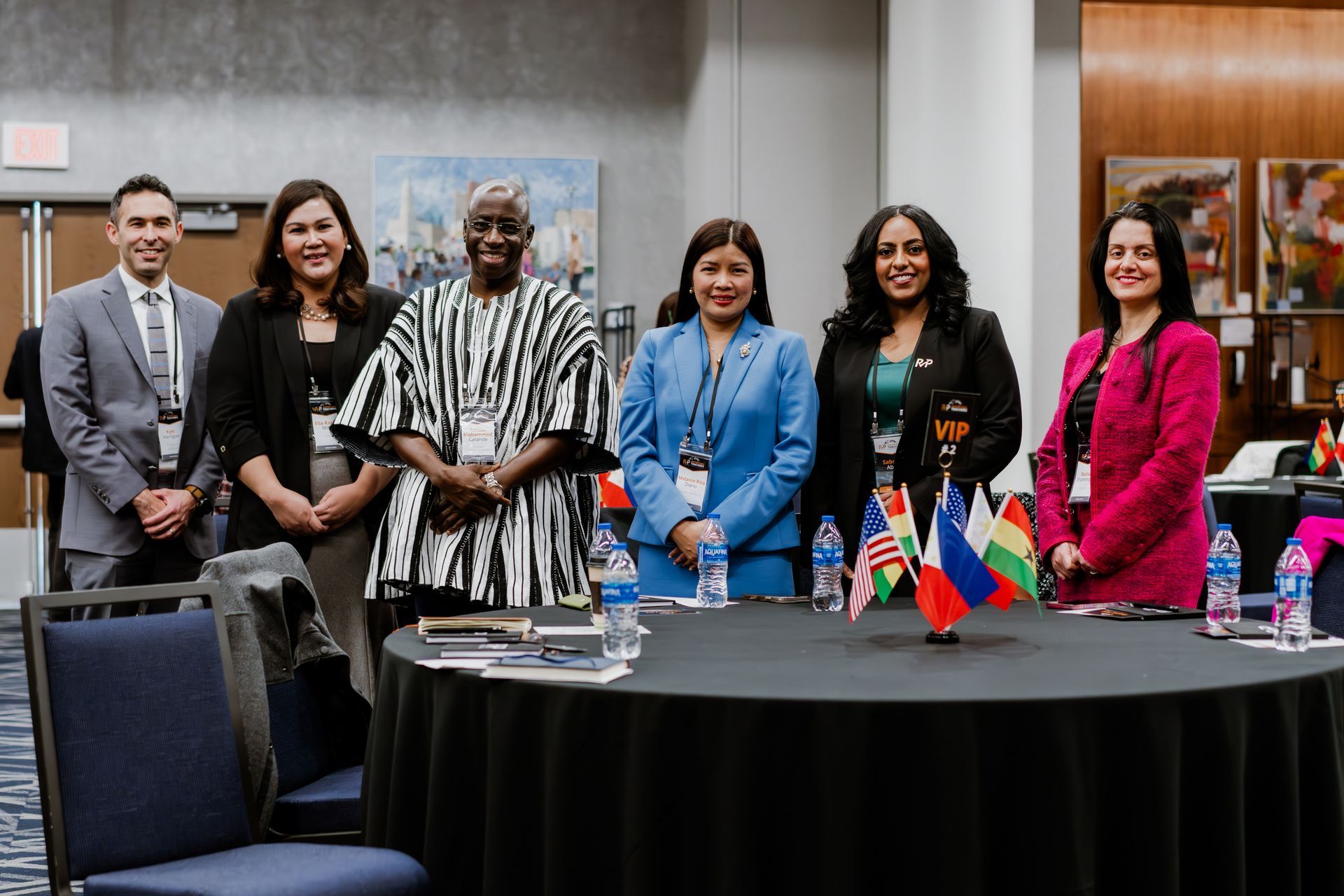 A group of people are sitting at a table holding wine glasses.