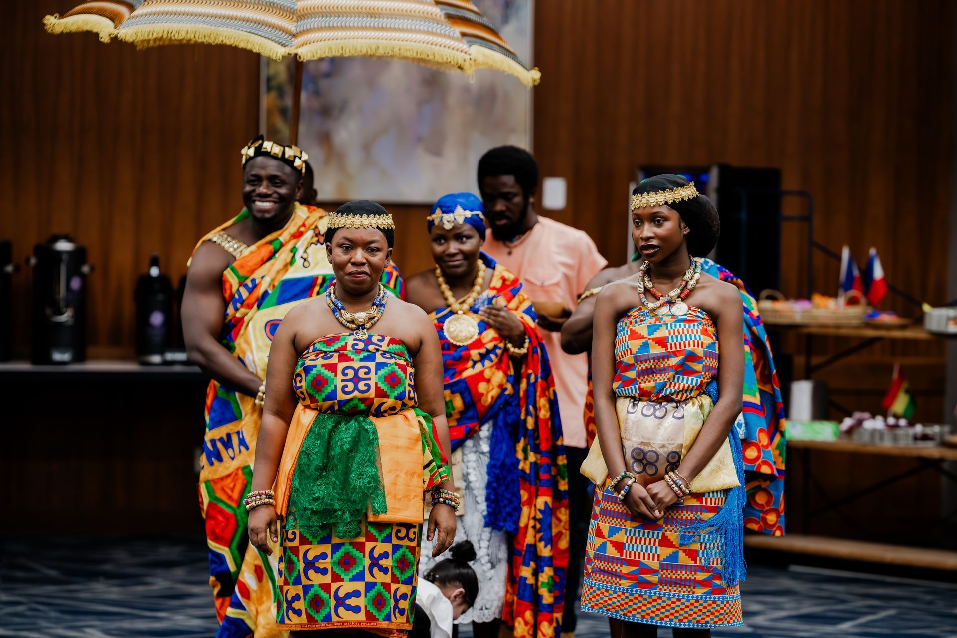 A group of people are standing next to each other in traditional african clothing.