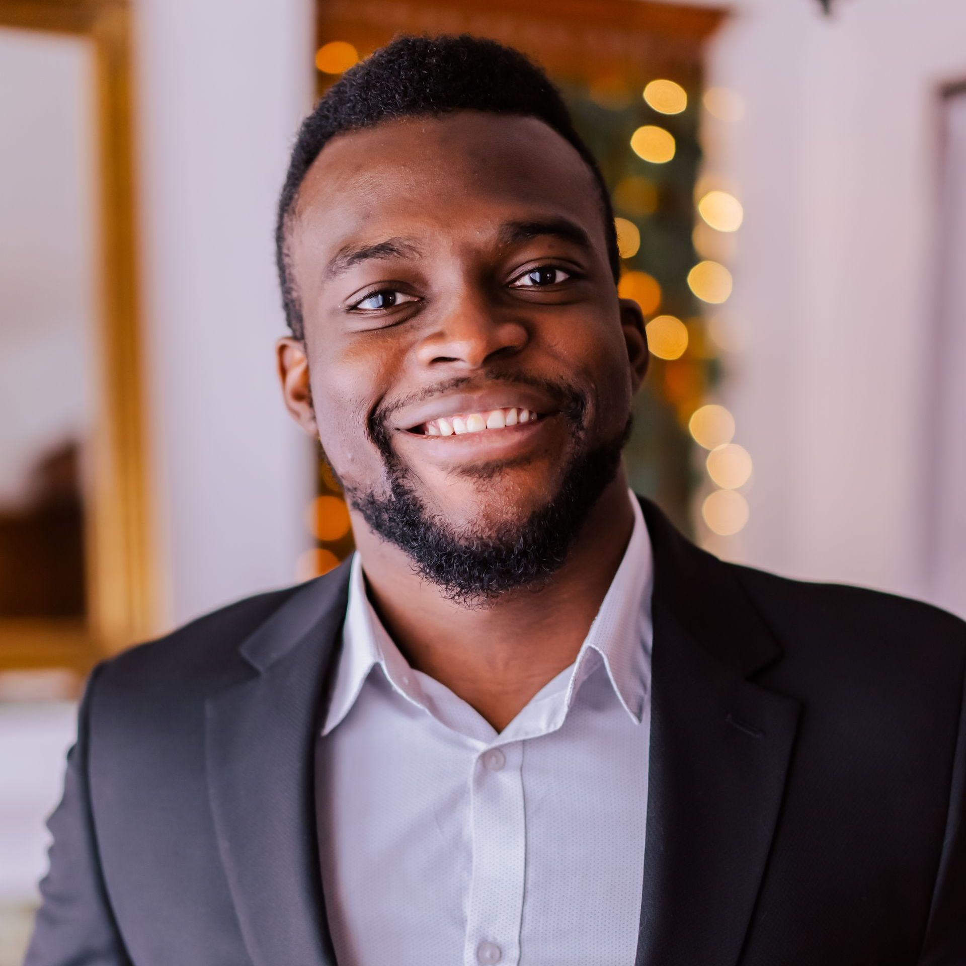 a man in a suit and white shirt is smiling for the camera .