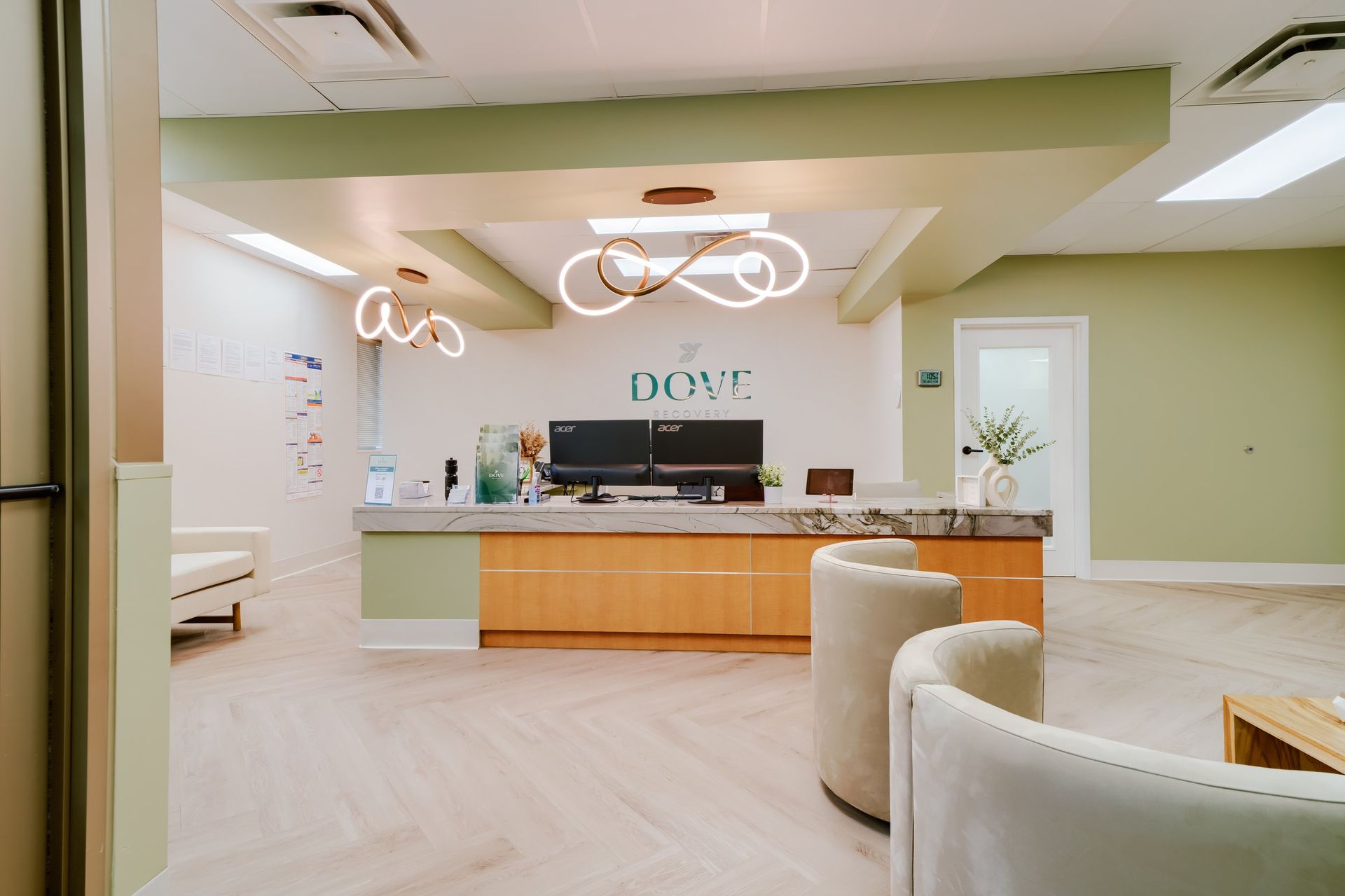 a lobby room with a counter and chairs in it .