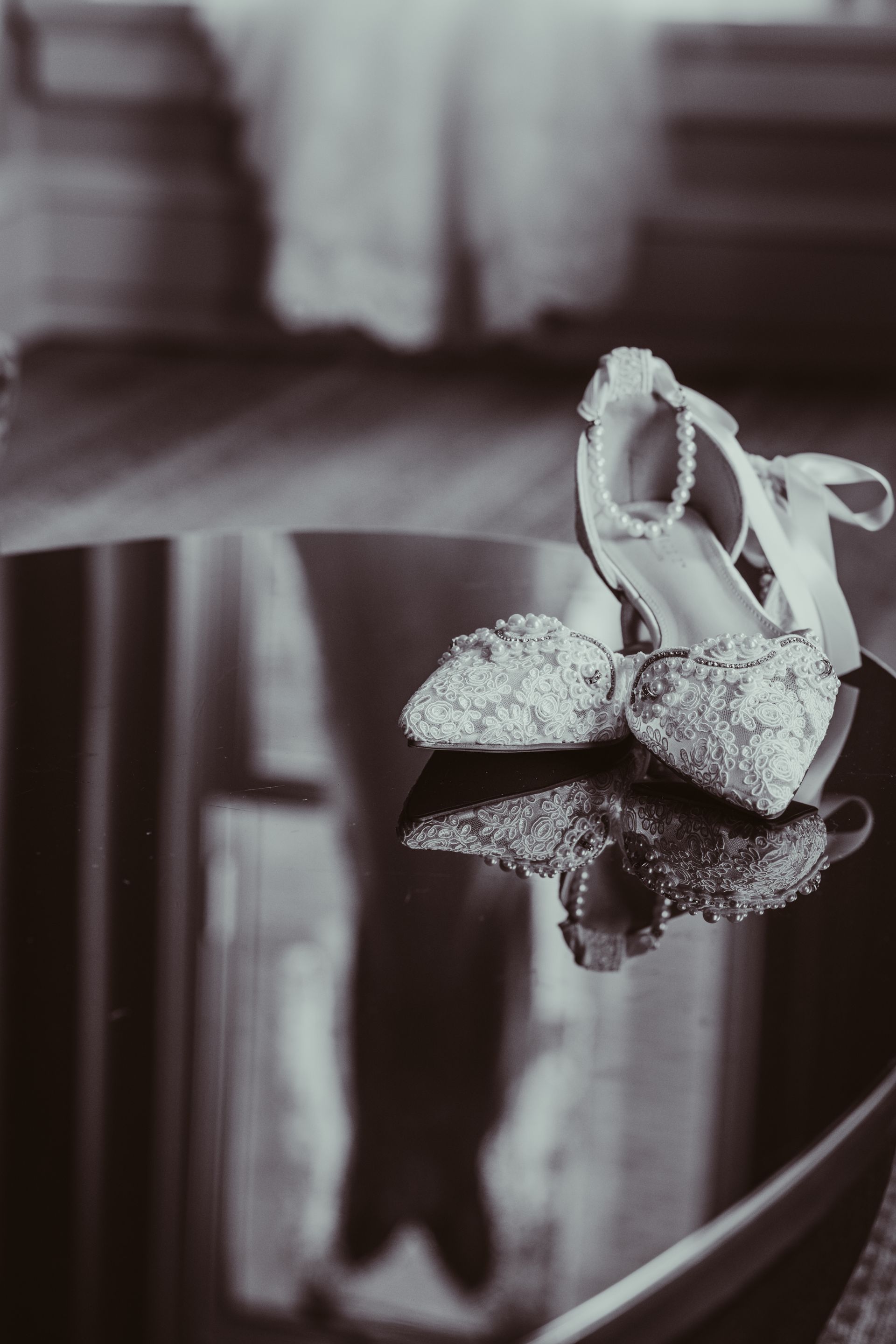 A pair of wedding shoes are sitting on a table.