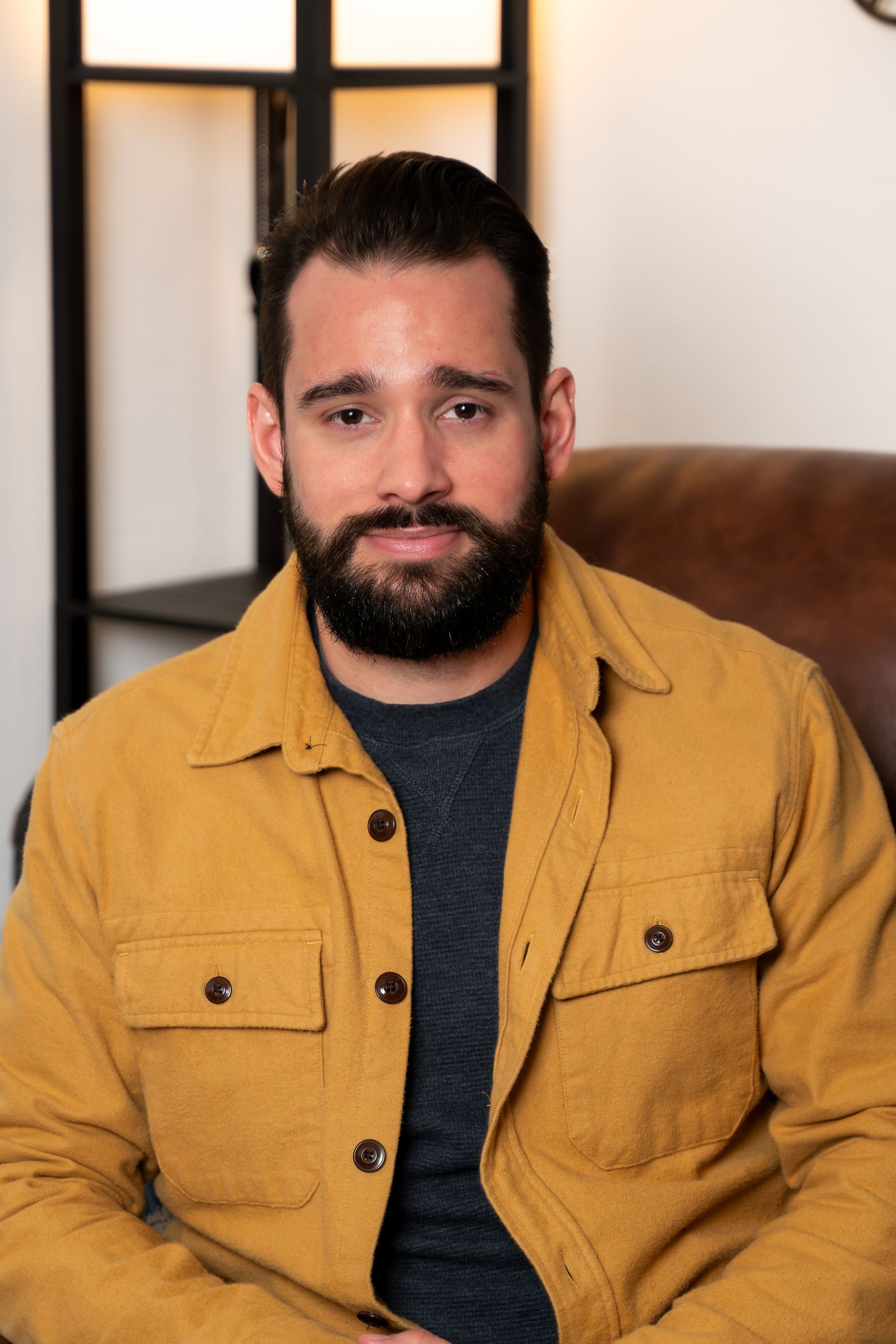 a woman in a purple dress is standing in front of a christmas tree .