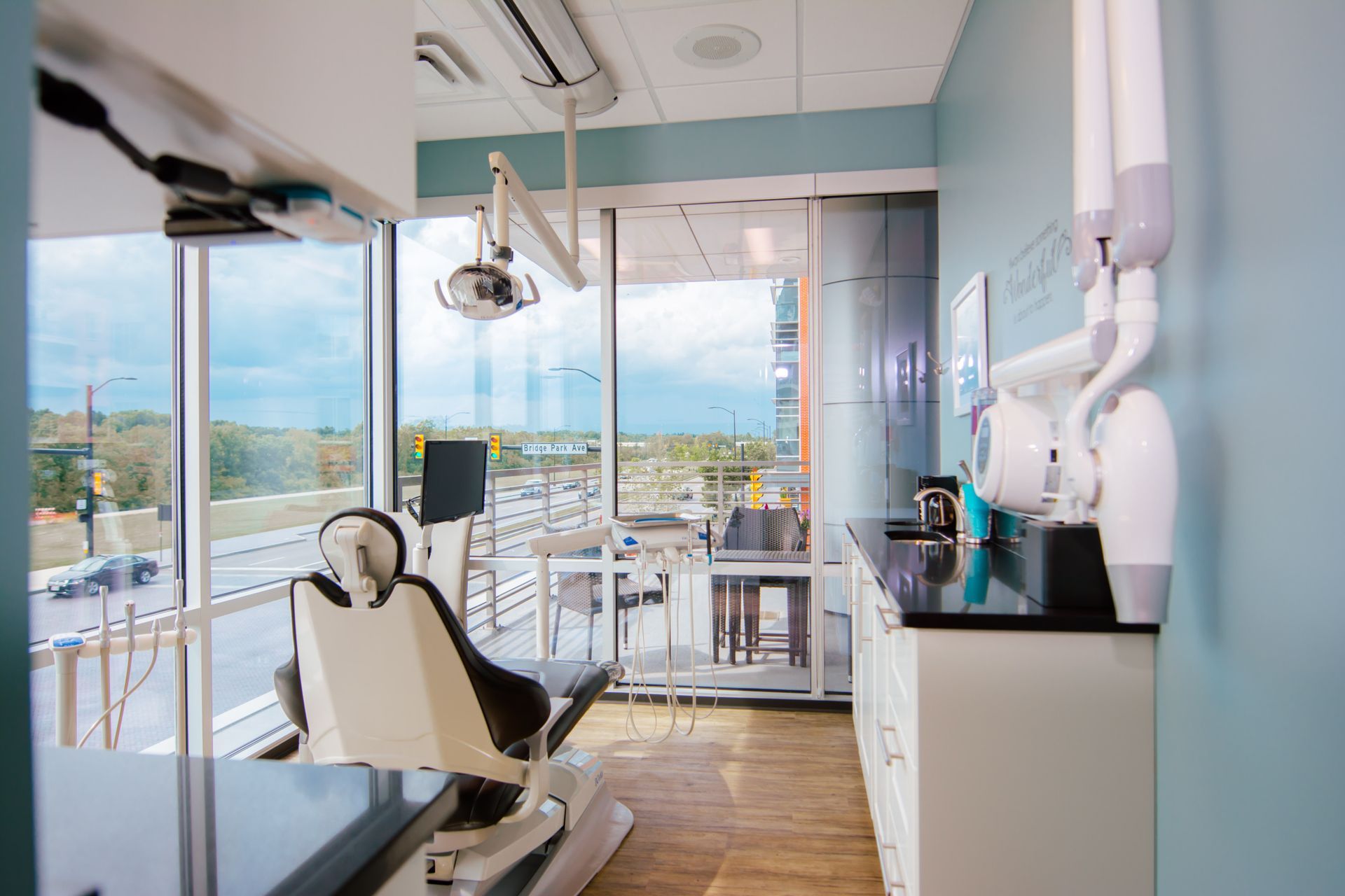 a woman is recording a man sitting in a chair with a camera .