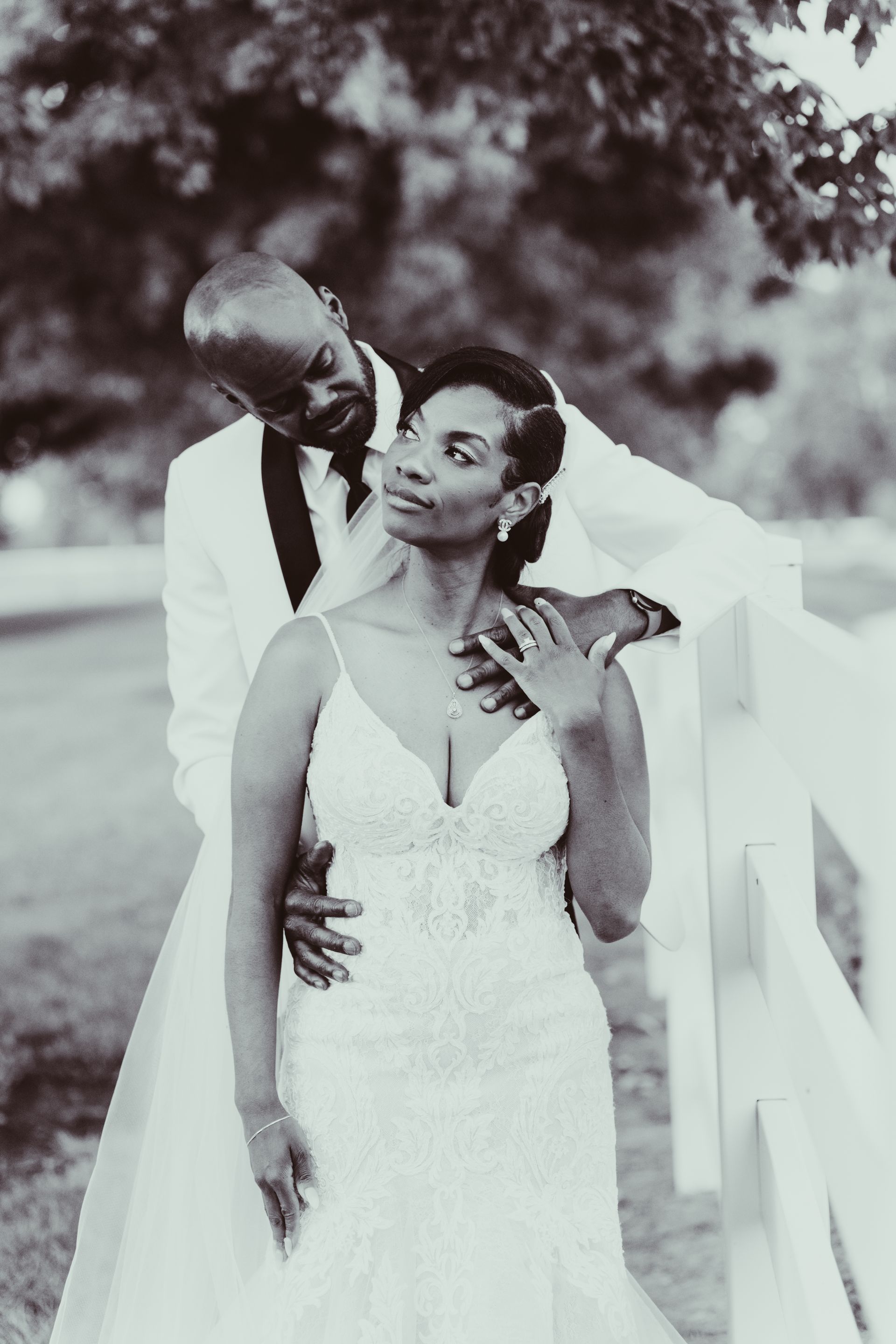 A black and white photo of a bride and groom posing for a picture.