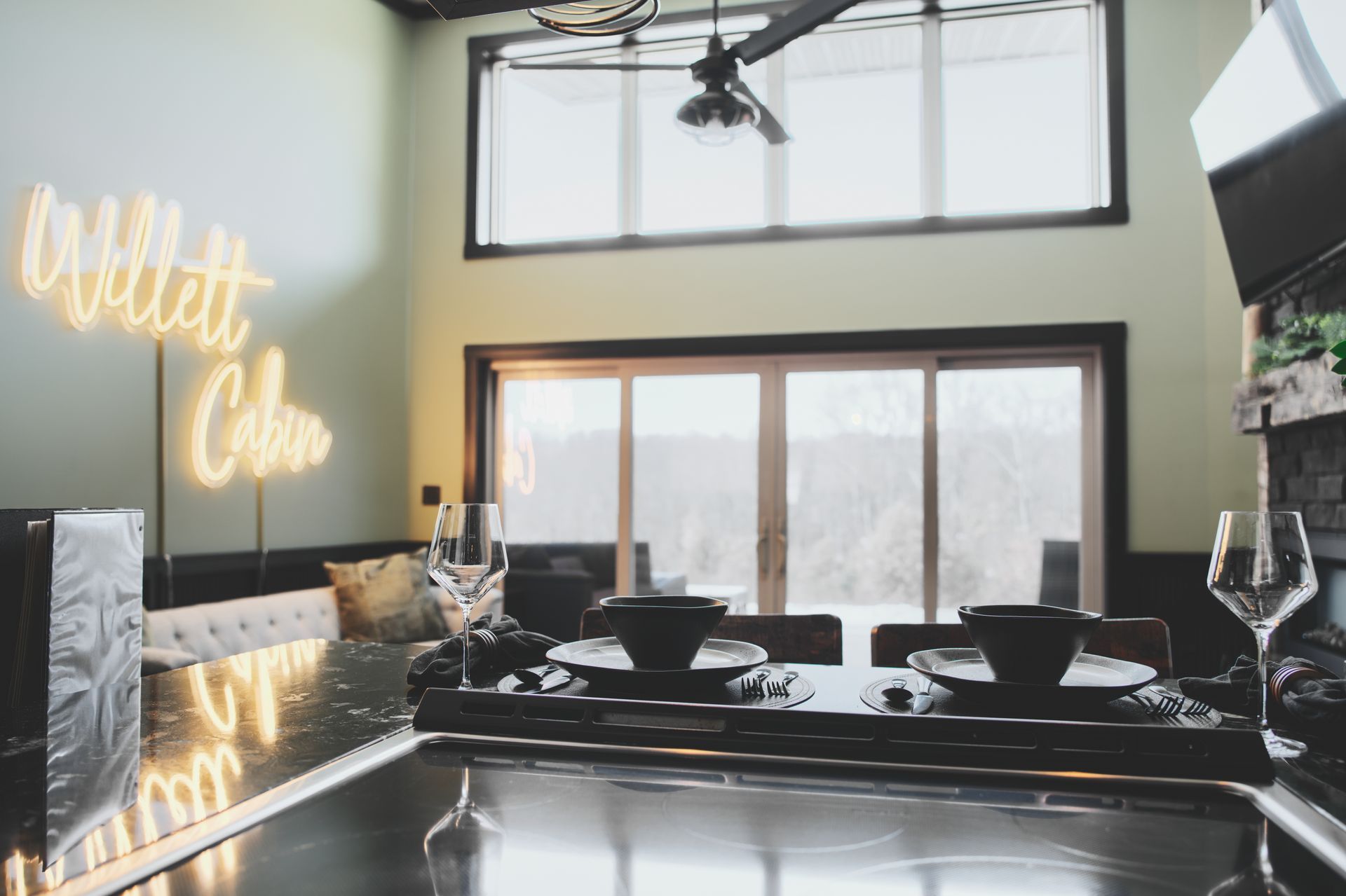 A kitchen with a neon sign that says willett cole on the wall.