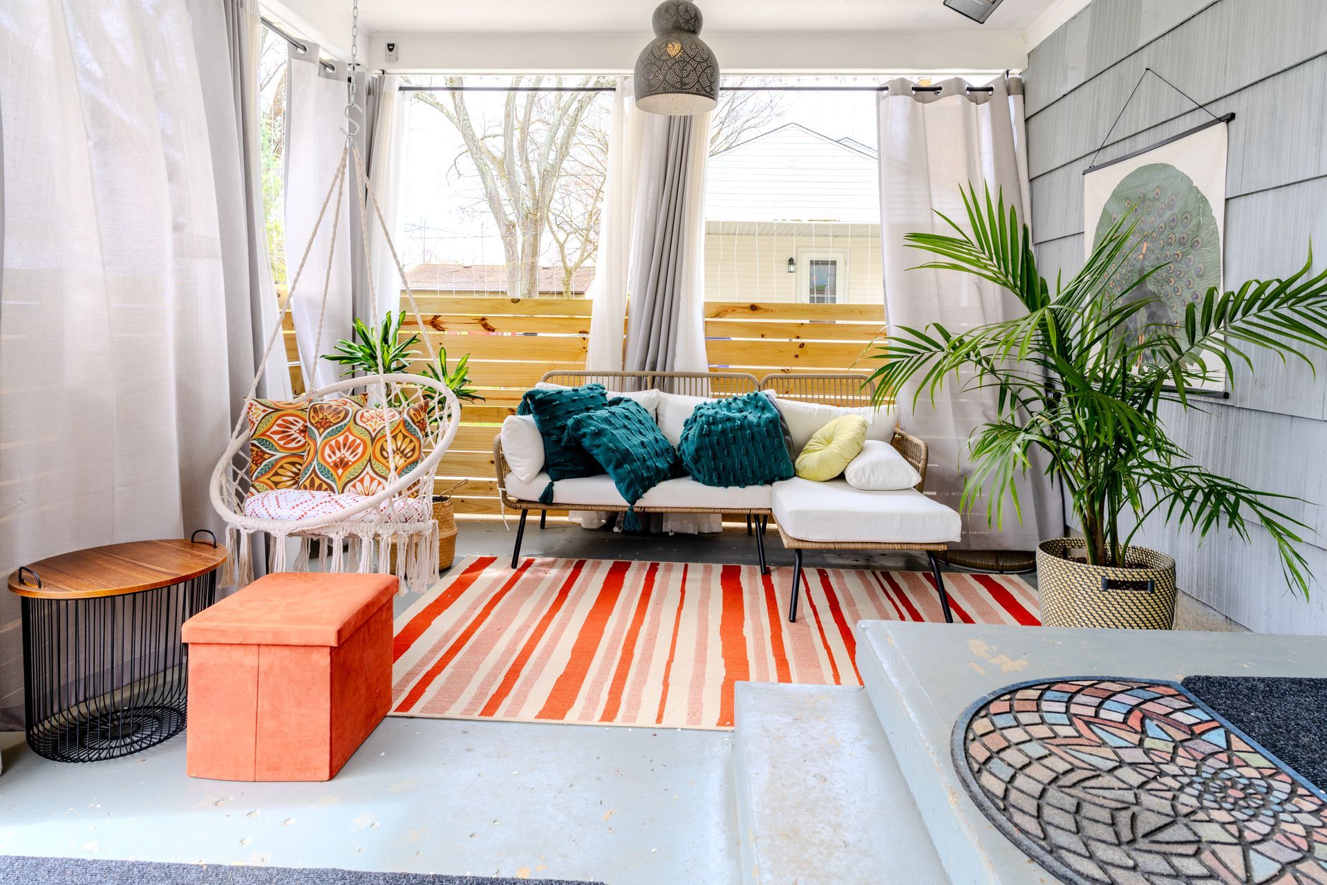A living room with a couch , chairs , and a rug.