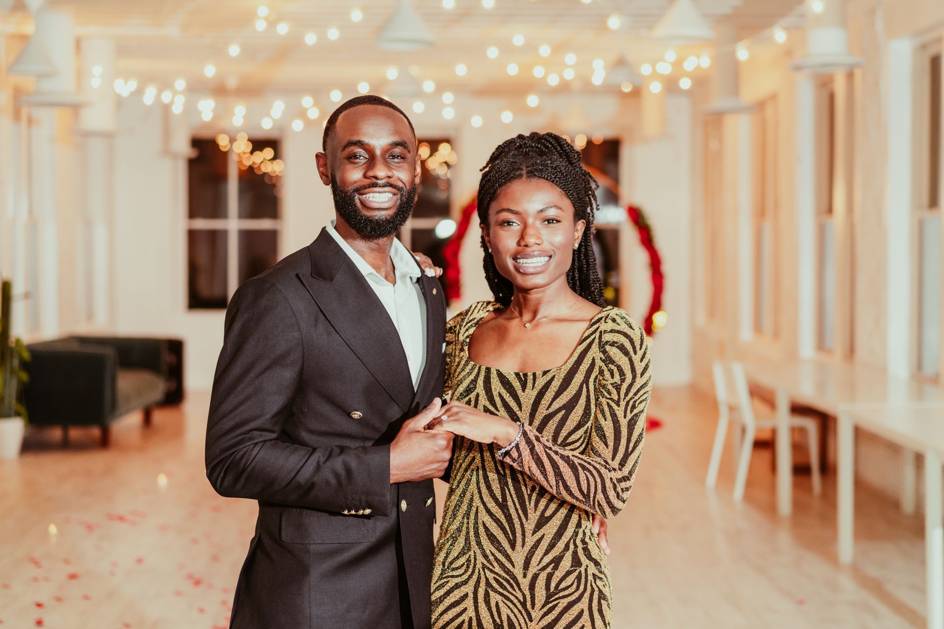A man and a woman are standing next to each other in a room.