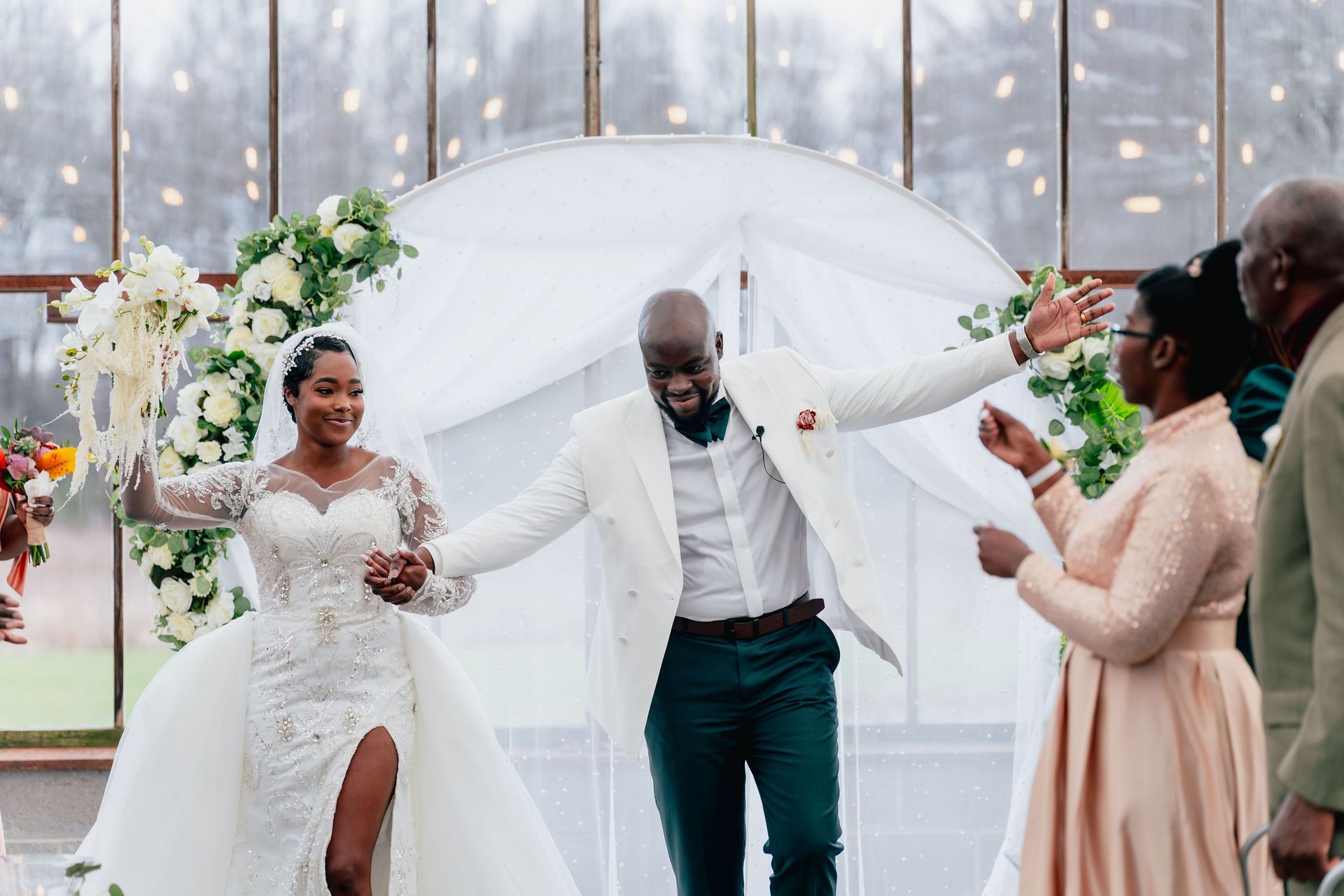 A bride and groom are walking down the aisle at their wedding.