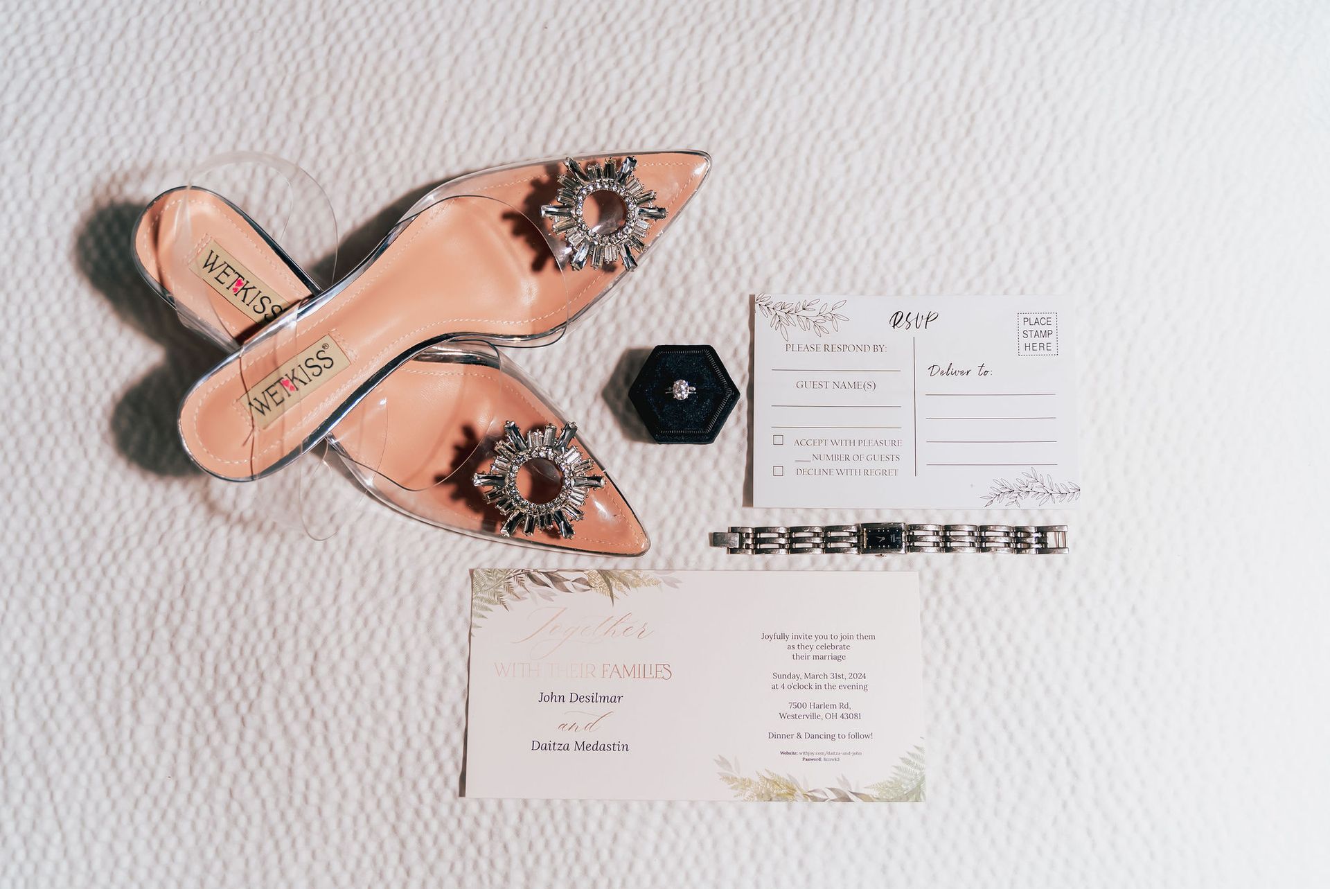 A pair of shoes and a ring are sitting on top of a table.