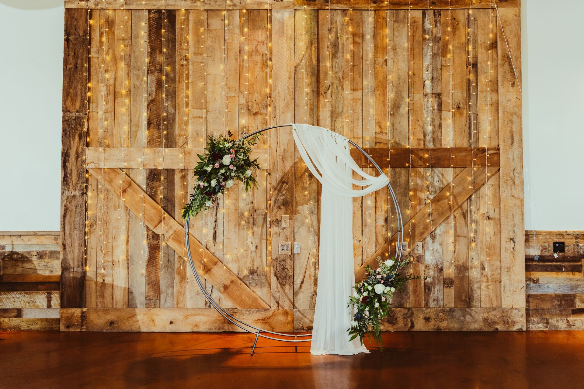 A wooden wall with a white podium in front of it.