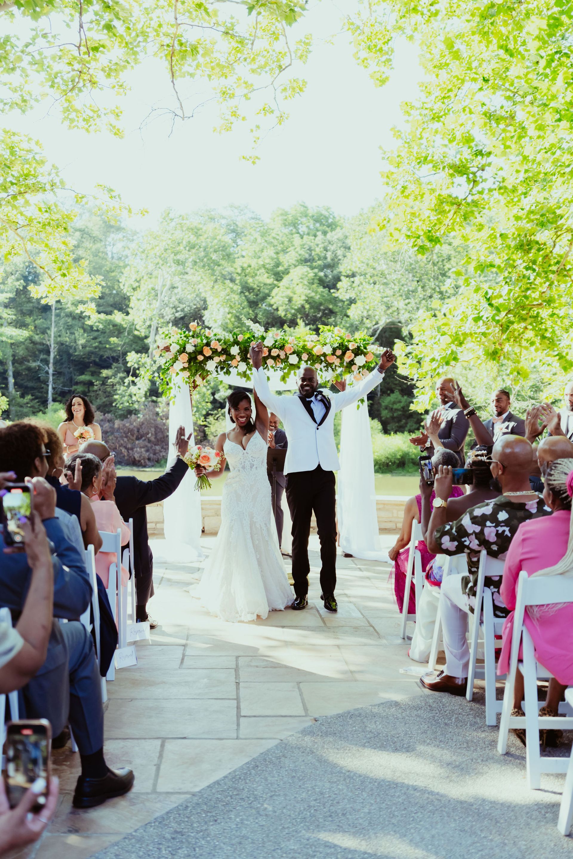 A bride and groom are walking down the aisle at their wedding.