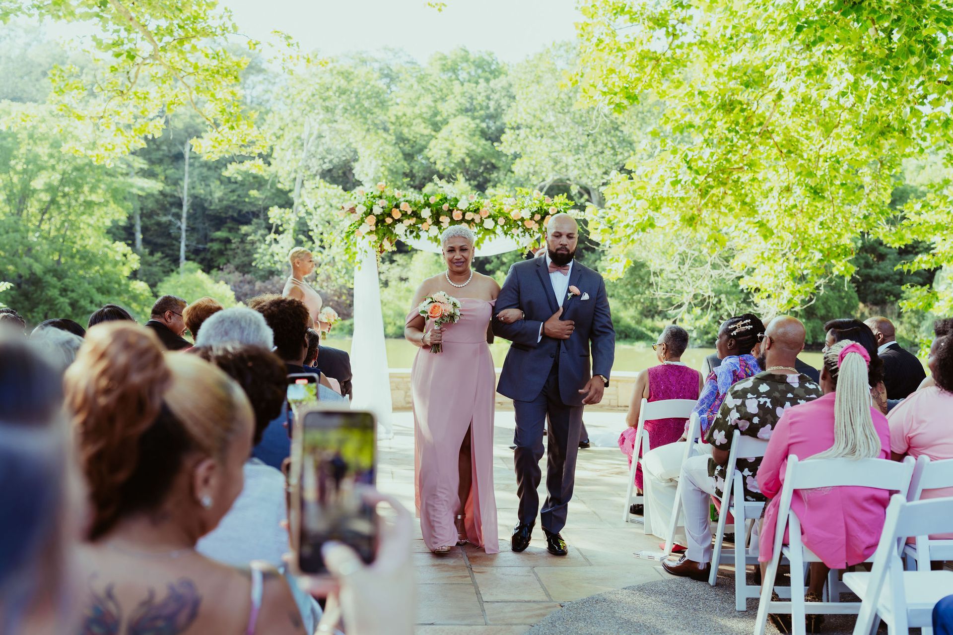 A bride and groom are walking down the aisle at a wedding ceremony.