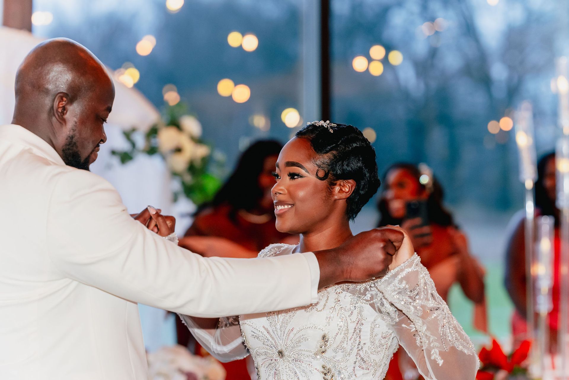 A bride and groom are dancing at their wedding reception.