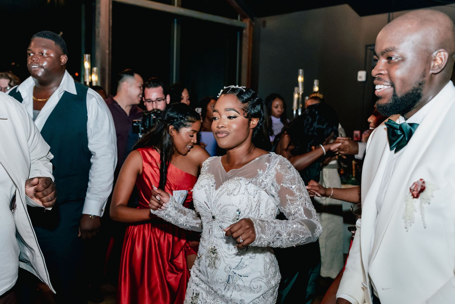 A bride and groom are dancing at their wedding reception.
