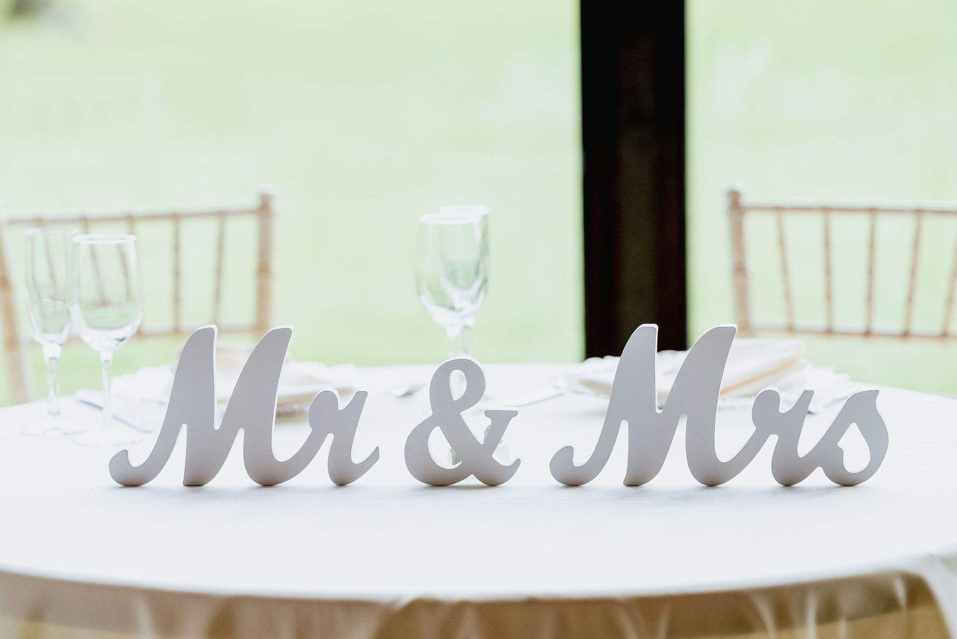 A table with a sign that says mr. and mrs. on it.