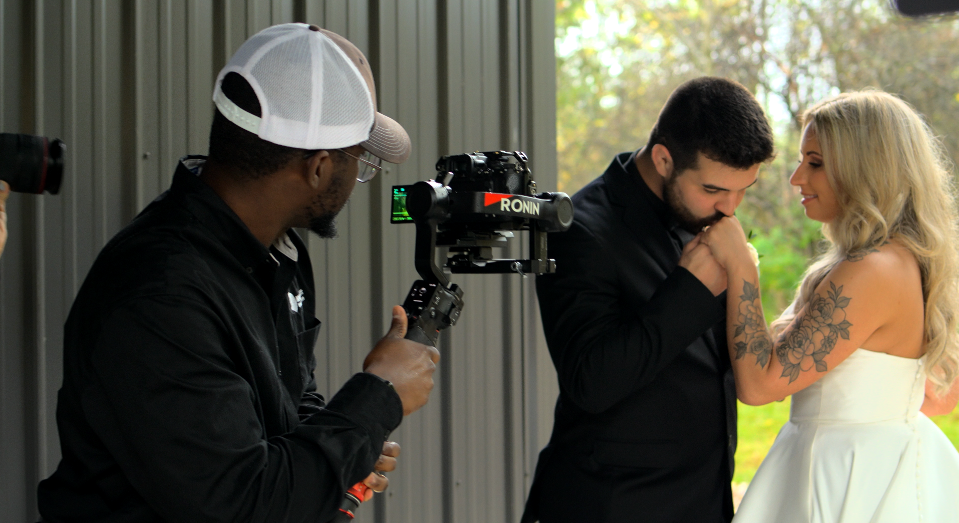 A man is taking a picture of a bride and groom Retreat 21.