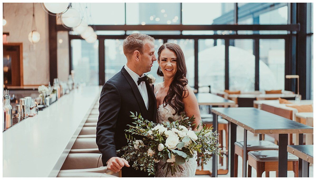 a bride and groom are posing for a picture in a restaurant .
