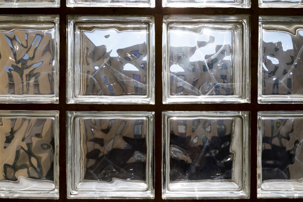 Glass block window, clear blocks with a distorted view of buildings and sky.