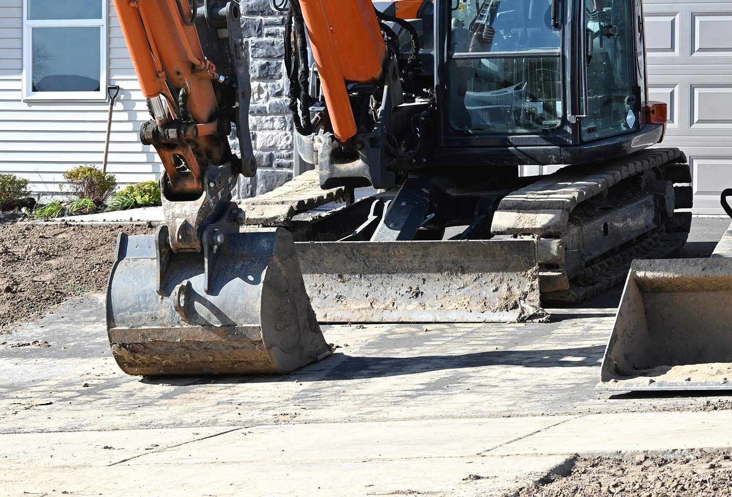 Large Excavator in Front of a House