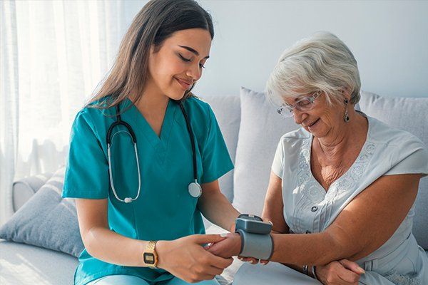 Caregiver Measuring Blood Pressure Of Senior — St. Louis, Missouri — Opulence Estate Solutions