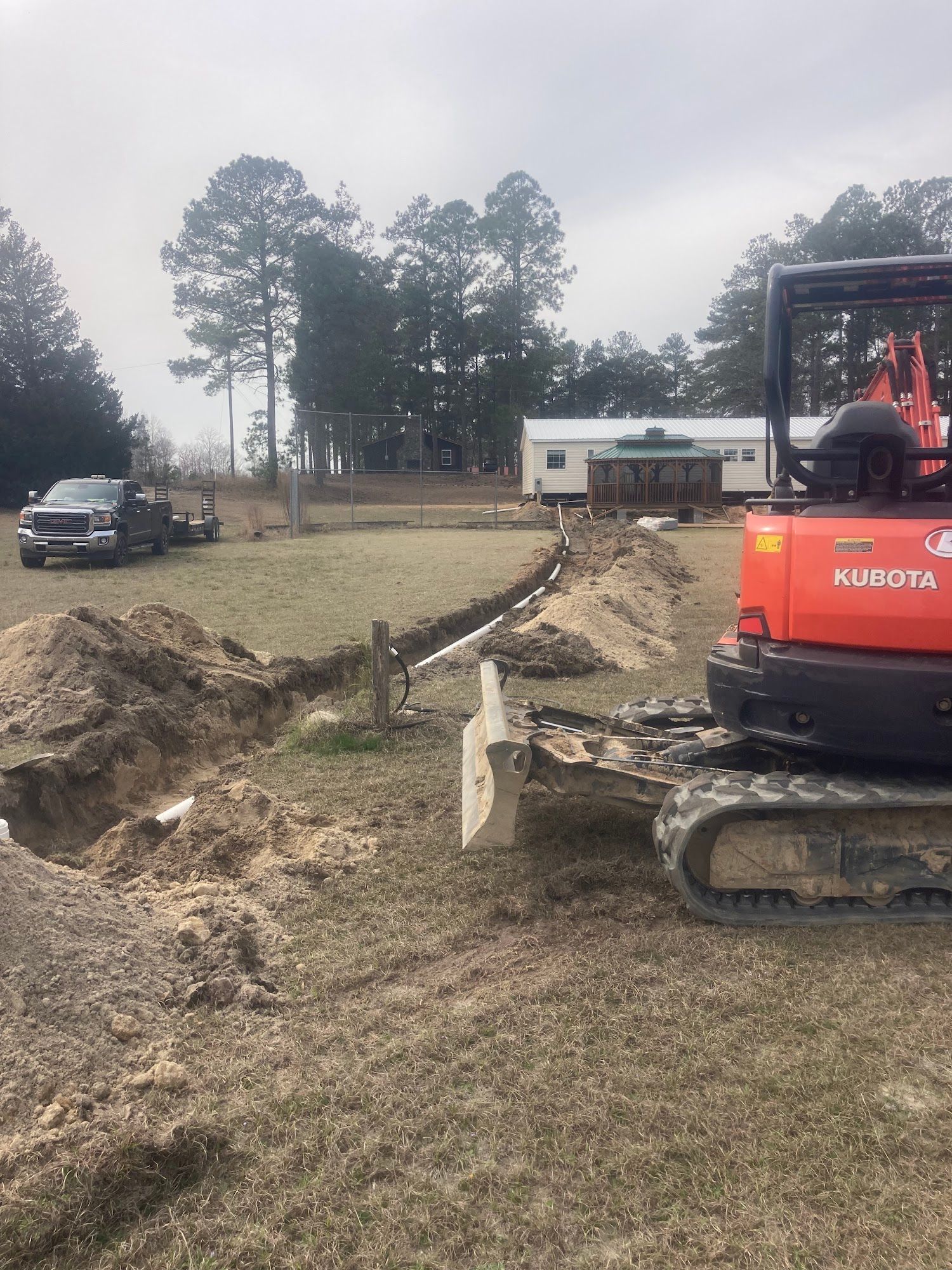 A bulldozer is digging a hole in the dirt in a field.