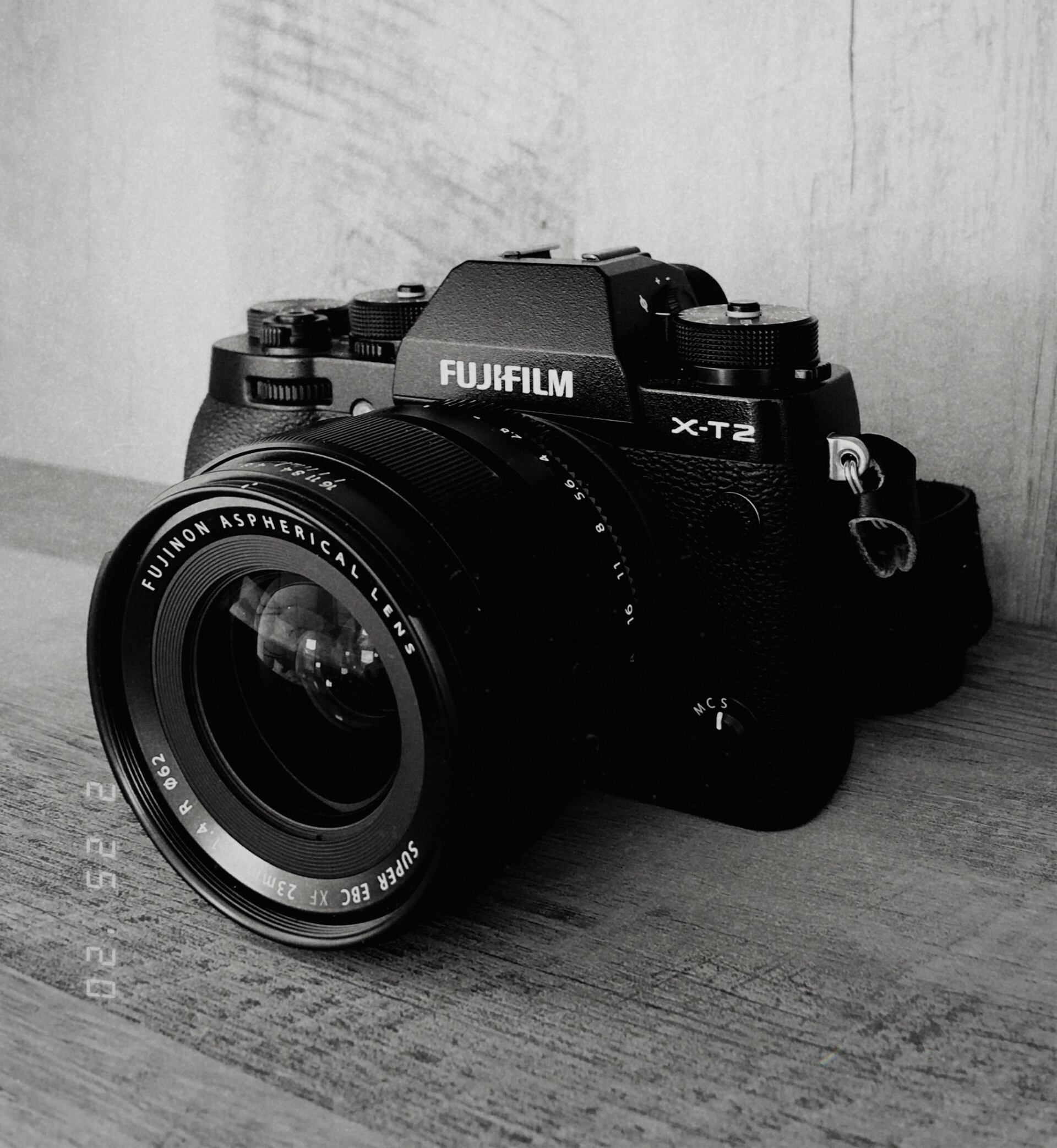 a black and white photo of a fujifilm camera