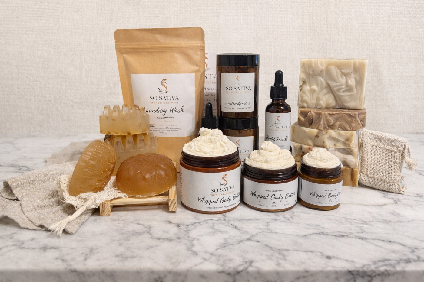 A collection of various skincare and body products, including soaps, body butters, and oils, arranged on a marble surface.