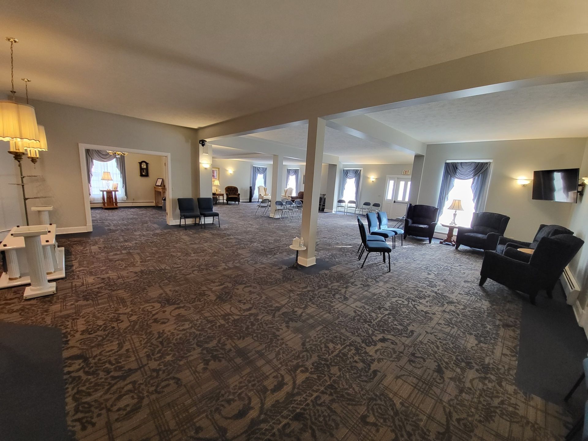 A church with rows of wooden benches and a podium