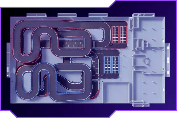Aerial view of The Grid indoor go-kart racing track in Pleasant Grove Utah showing multi-level layout with banked turns and corkscrew