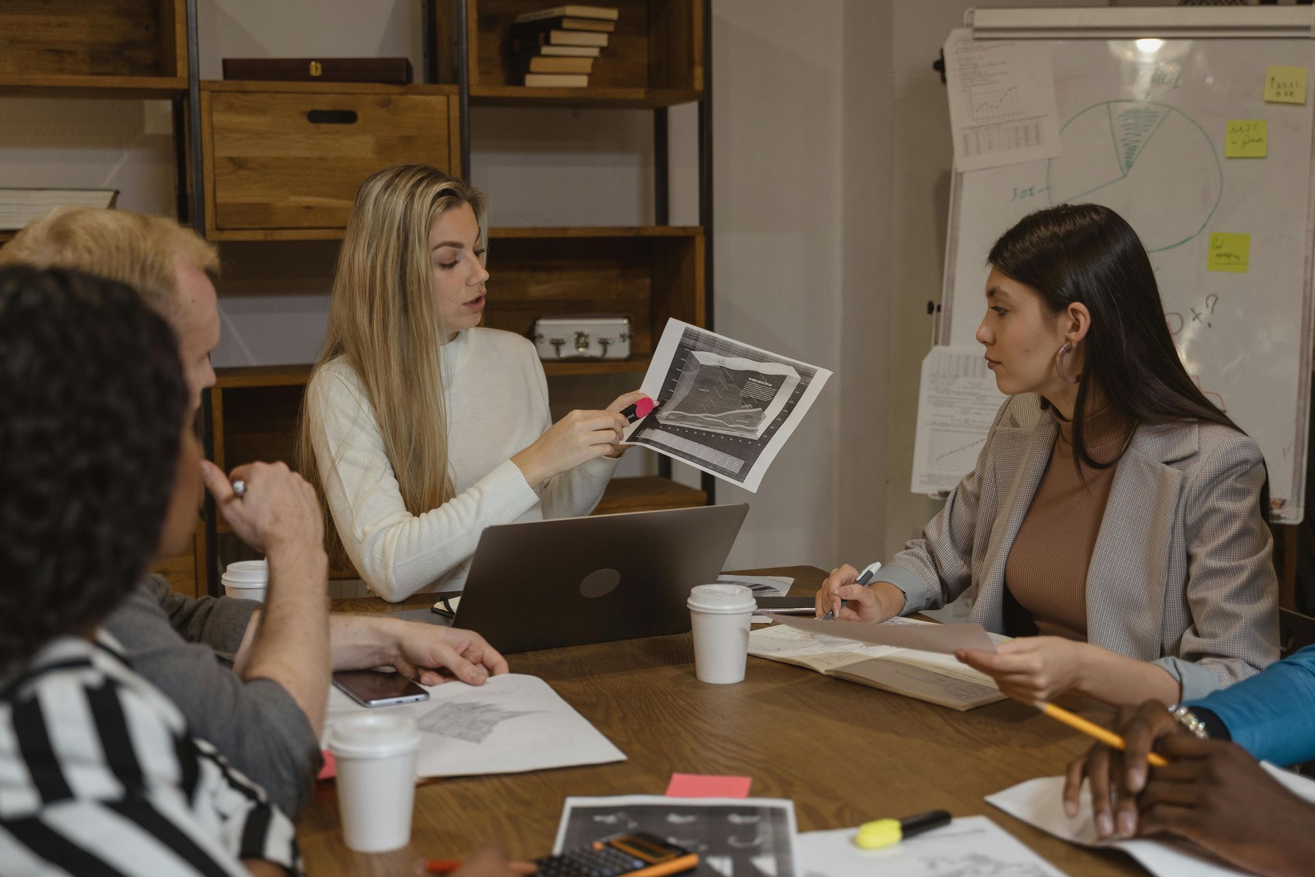 A group of businesspeople gather to review corporate performance and annual compliance.
