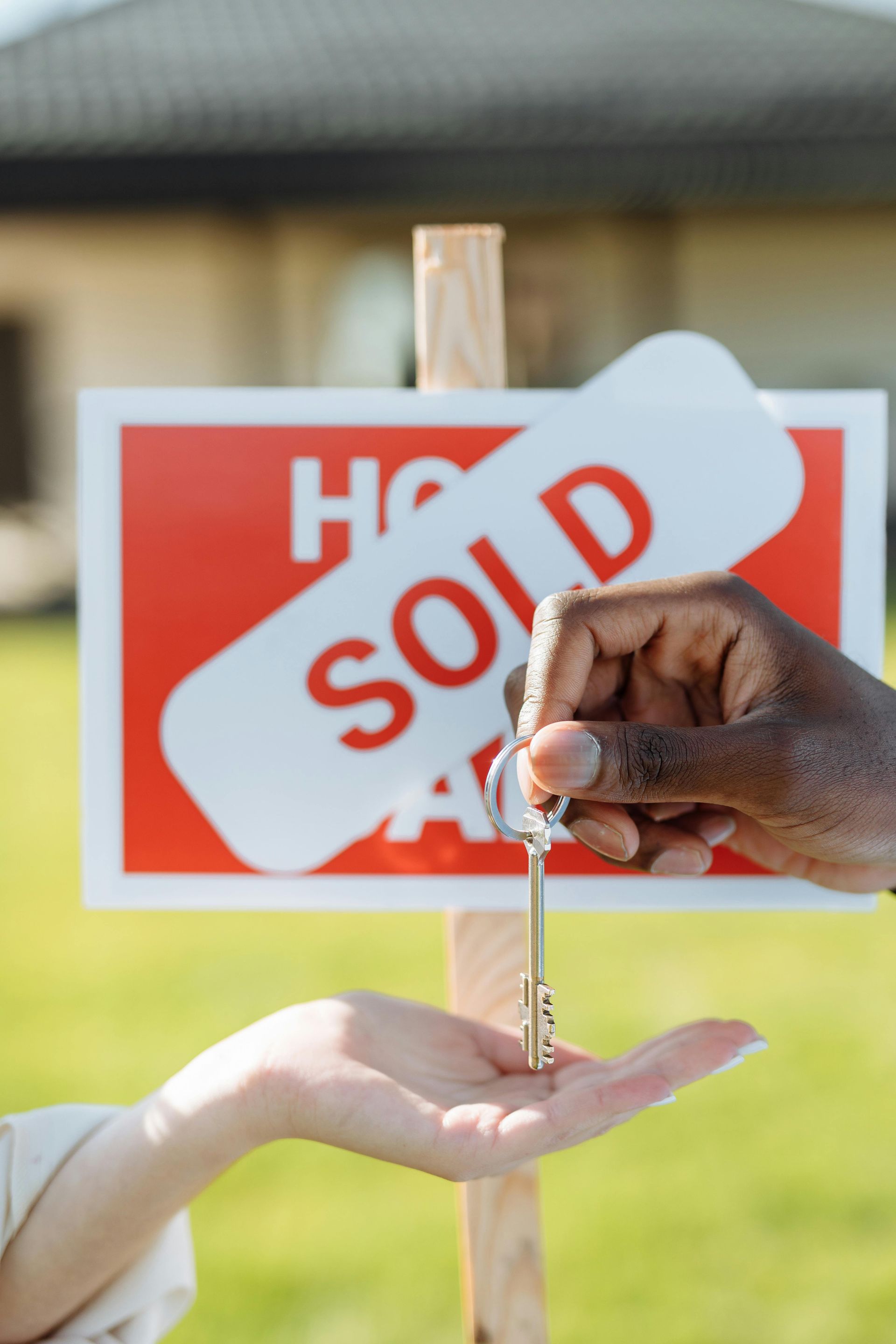 A house is shown behind a For Sale sign with 