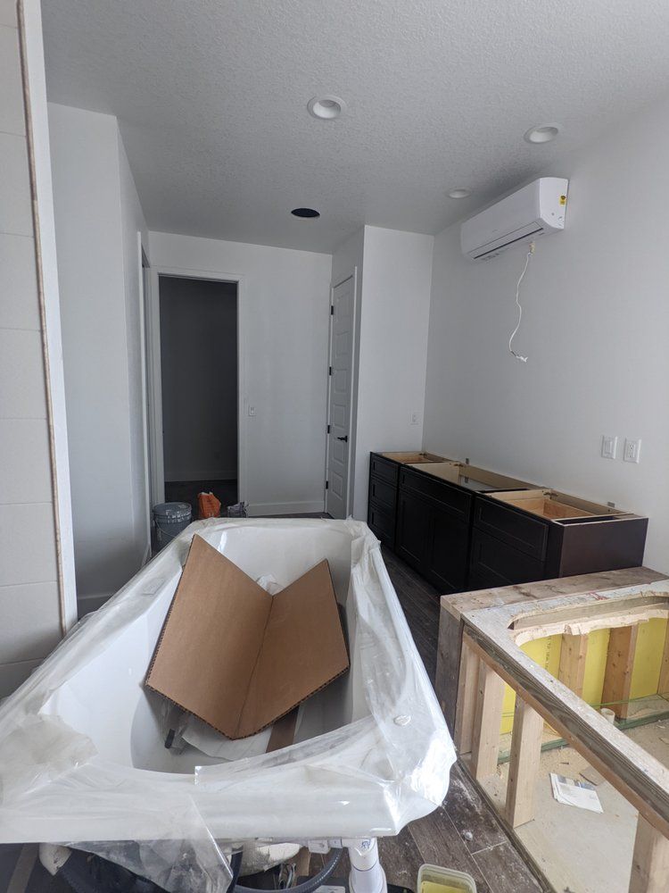 A cardboard box is sitting on top of a bathtub in a room.