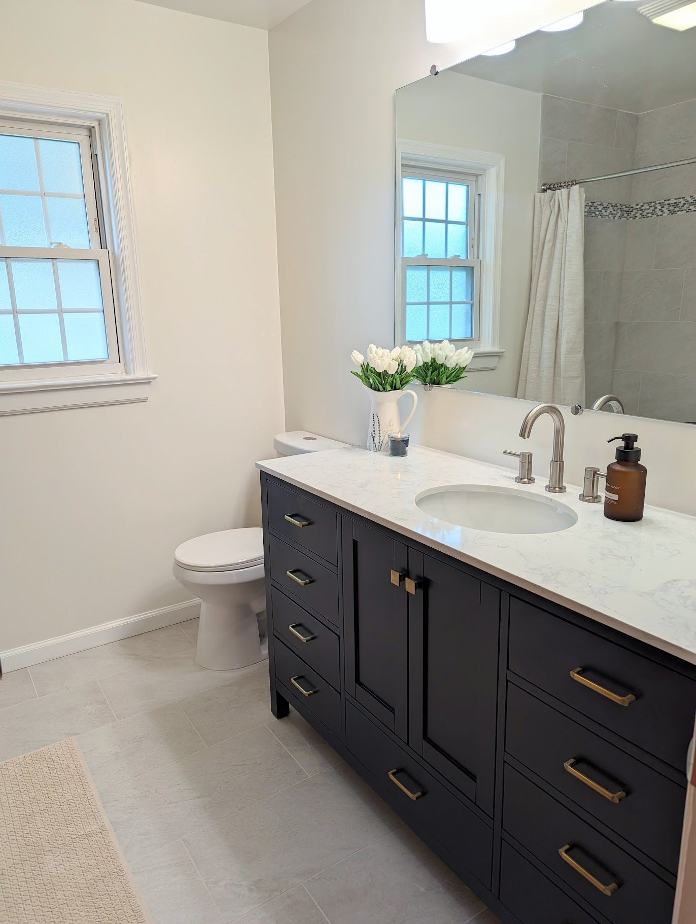 A bathroom with a sink , toilet , and mirror.