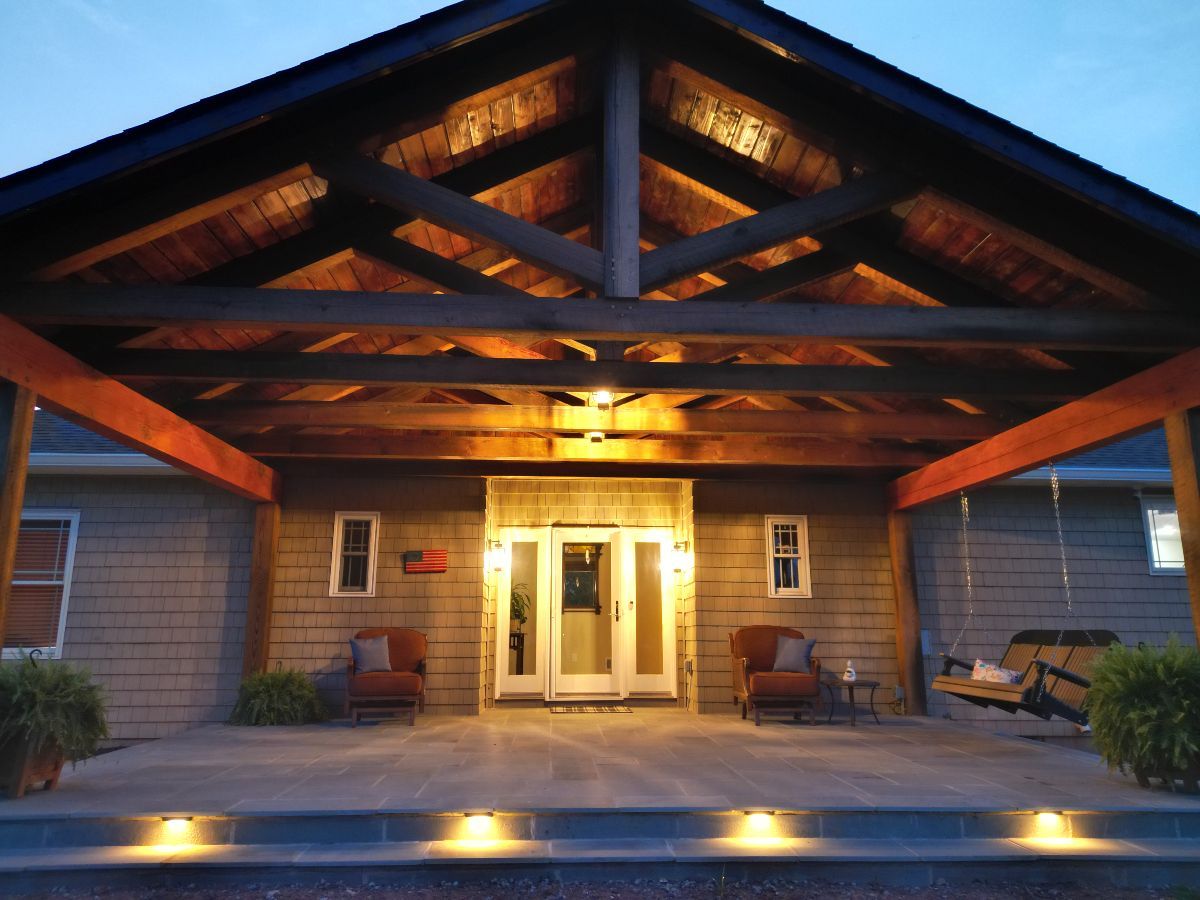 The front of a house with a porch and chairs