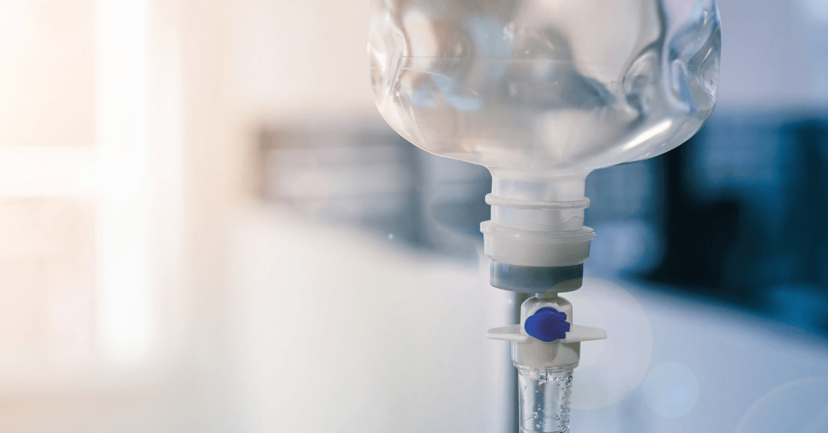 A close up of an iv drip in a hospital room.