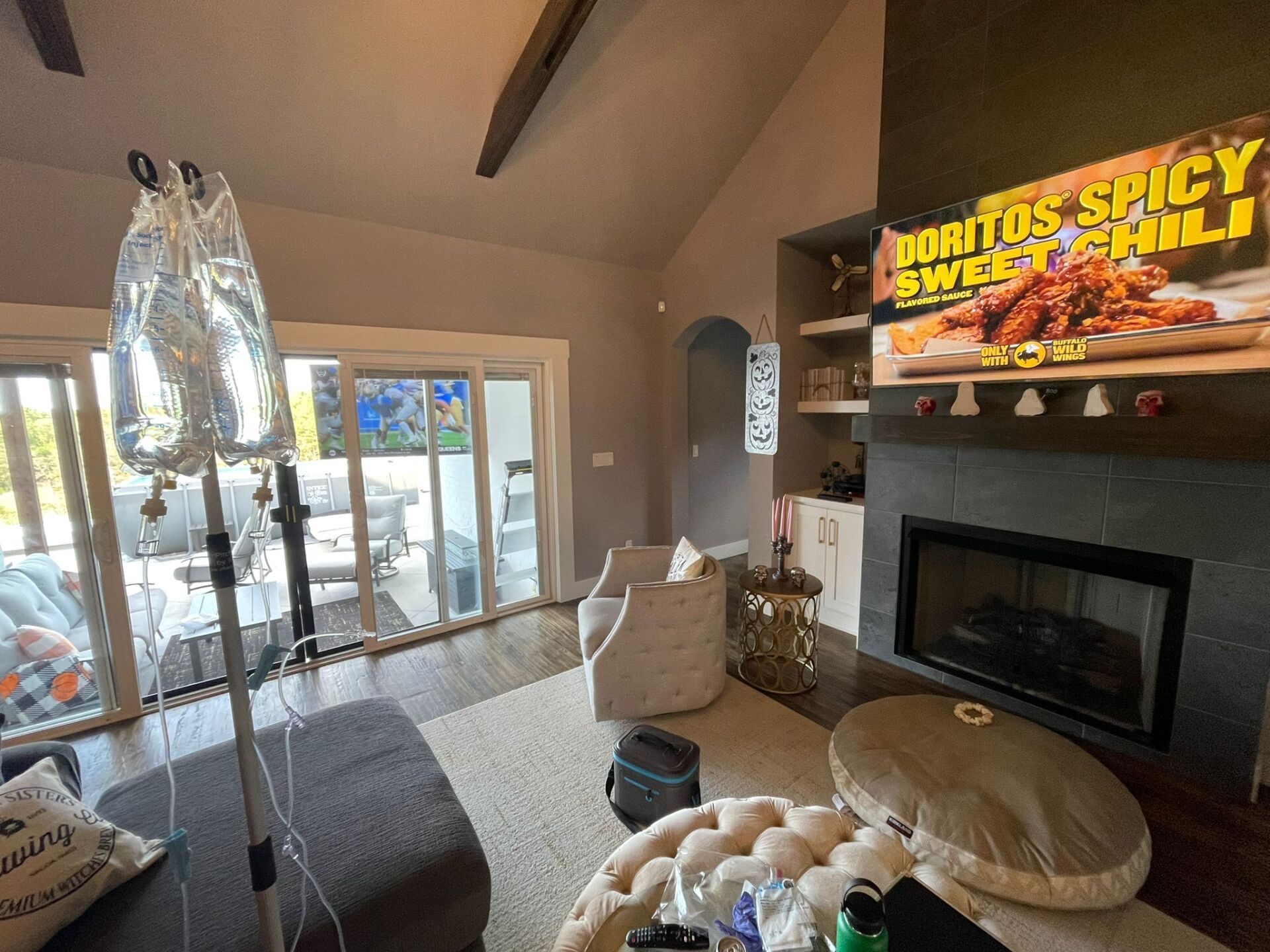 A living room with a fireplace and a sign that says doritos spice sweet chili.