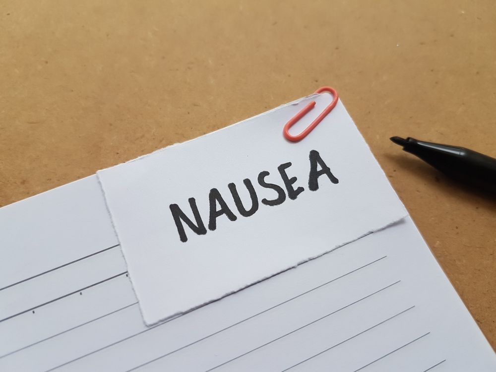 A piece of paper with the word nausea written on it