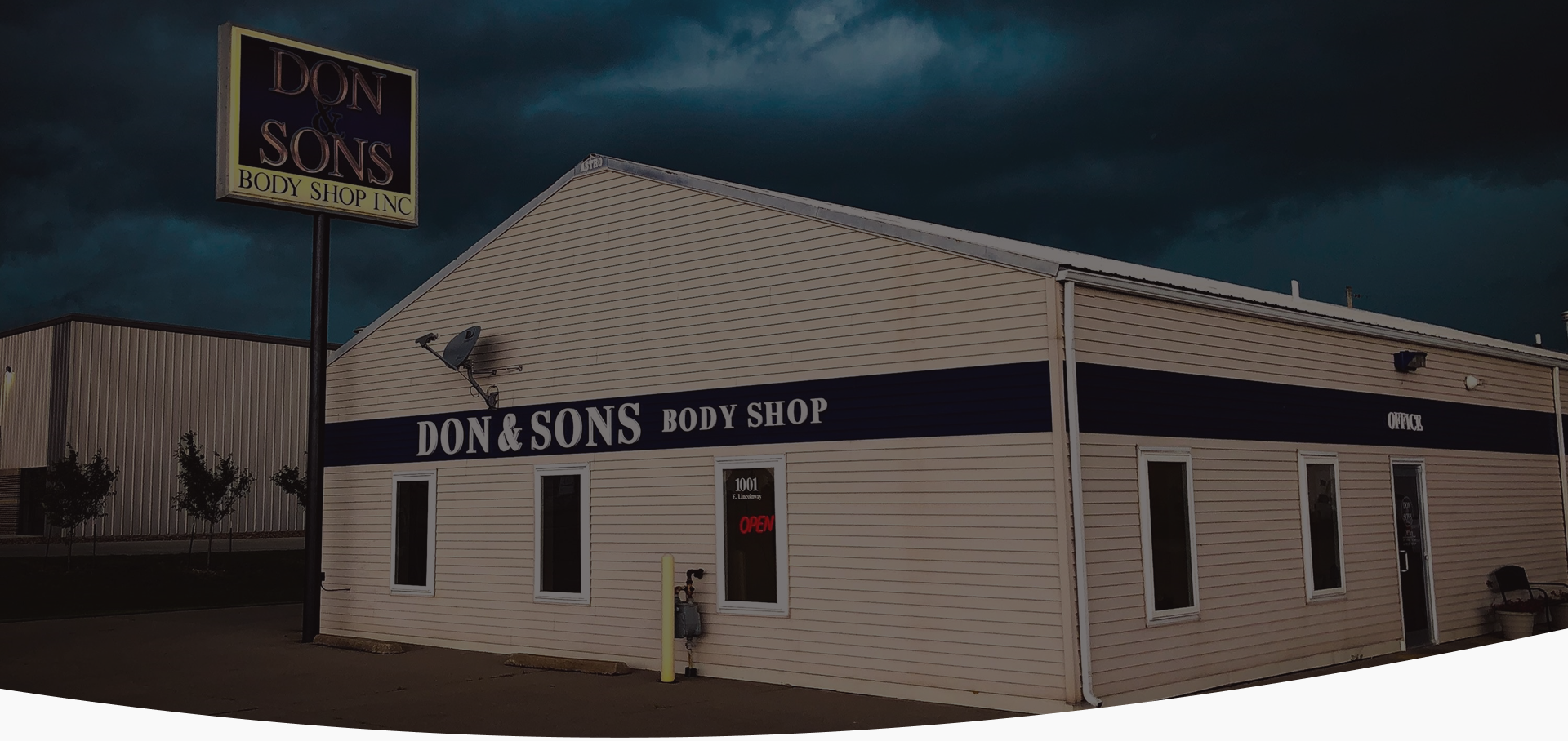 A building with a sign that says ' don & sons boot shop ' on it | Don & Sons Body Shop