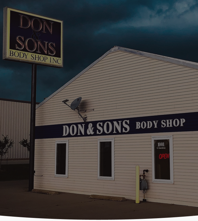 A building with a sign that says don & sons body shop | Don & Sons Body Shop