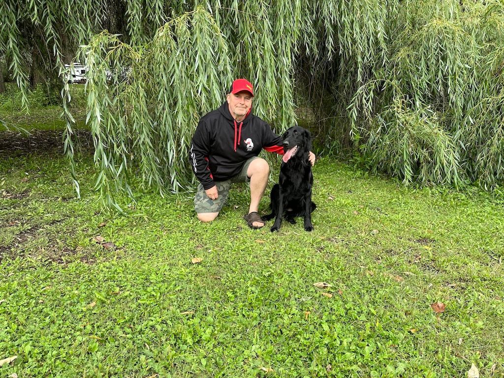 Man with his flatcoat retriever