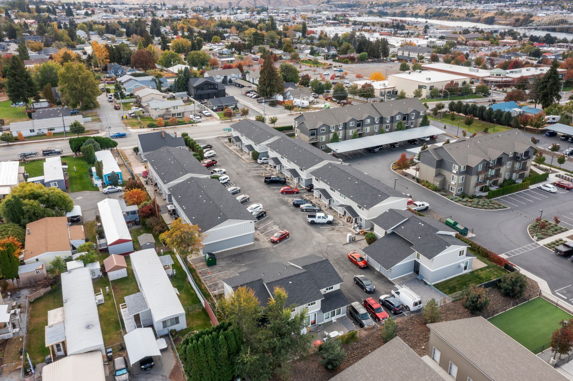 An aerial view of a residential area with lots of houses and cars parked in front of them.