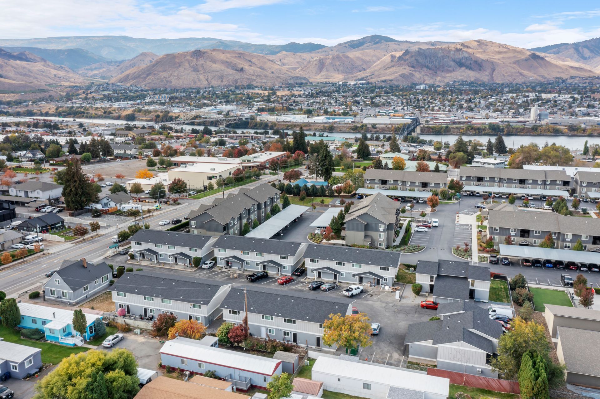An aerial view of a residential area with mountains in the background.