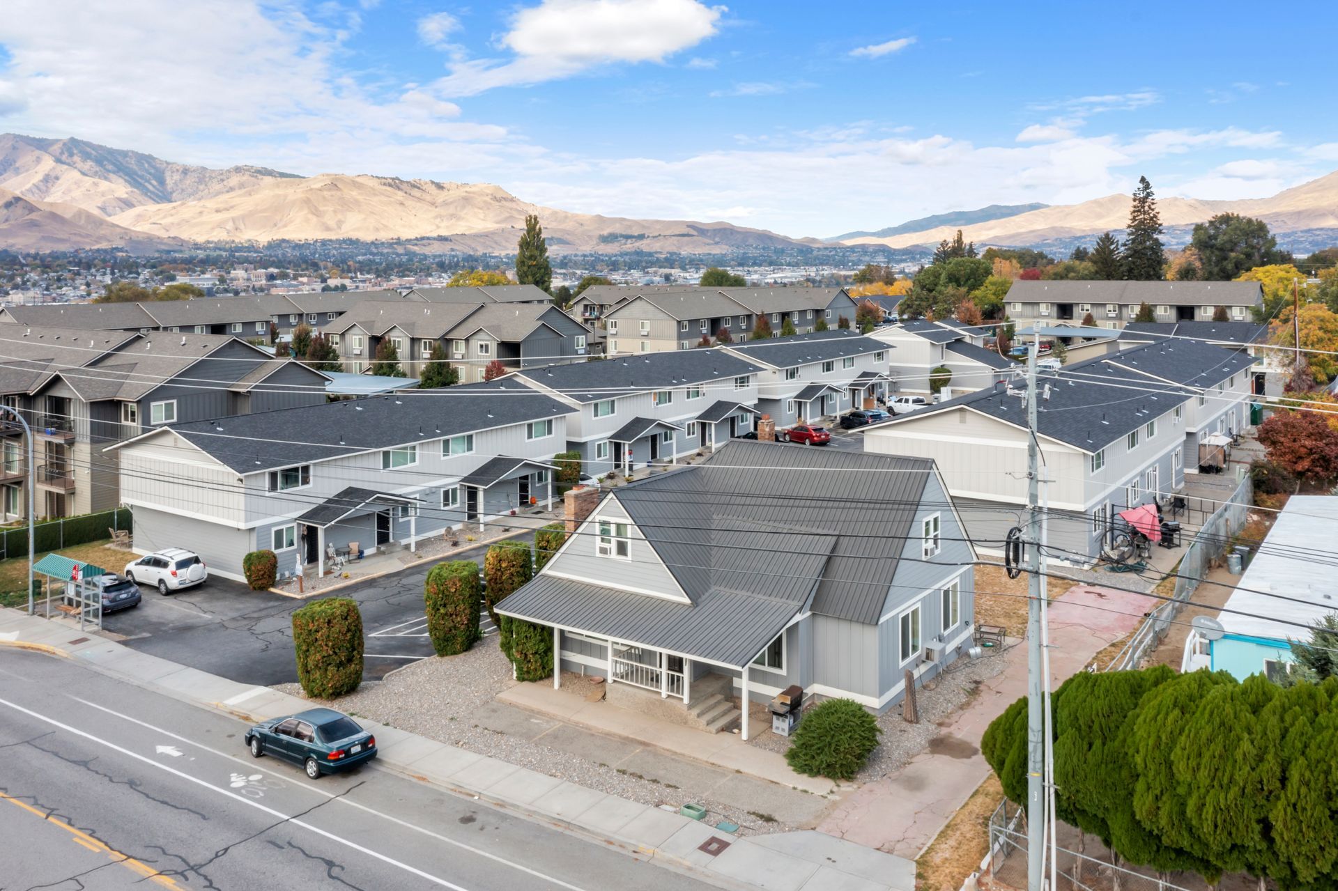 An aerial view of a residential area with mountains in the background.