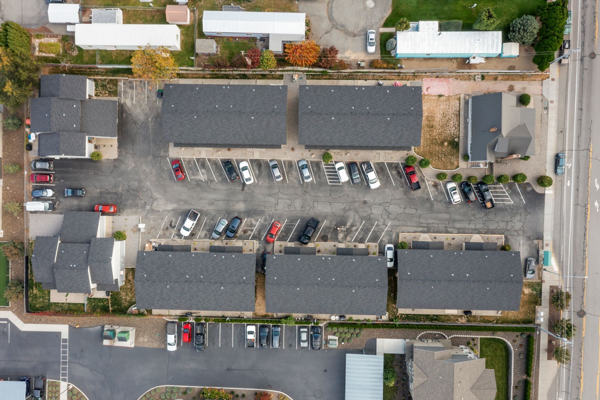An aerial view of a parking lot with cars parked in it