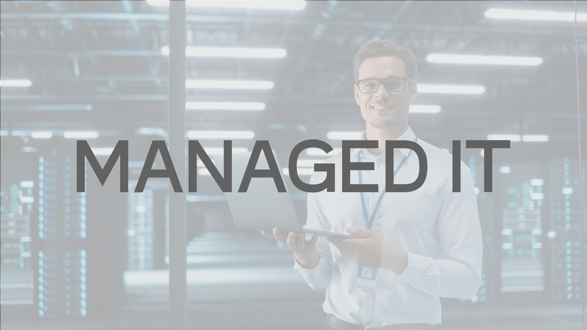 Man holding laptop in server room, 