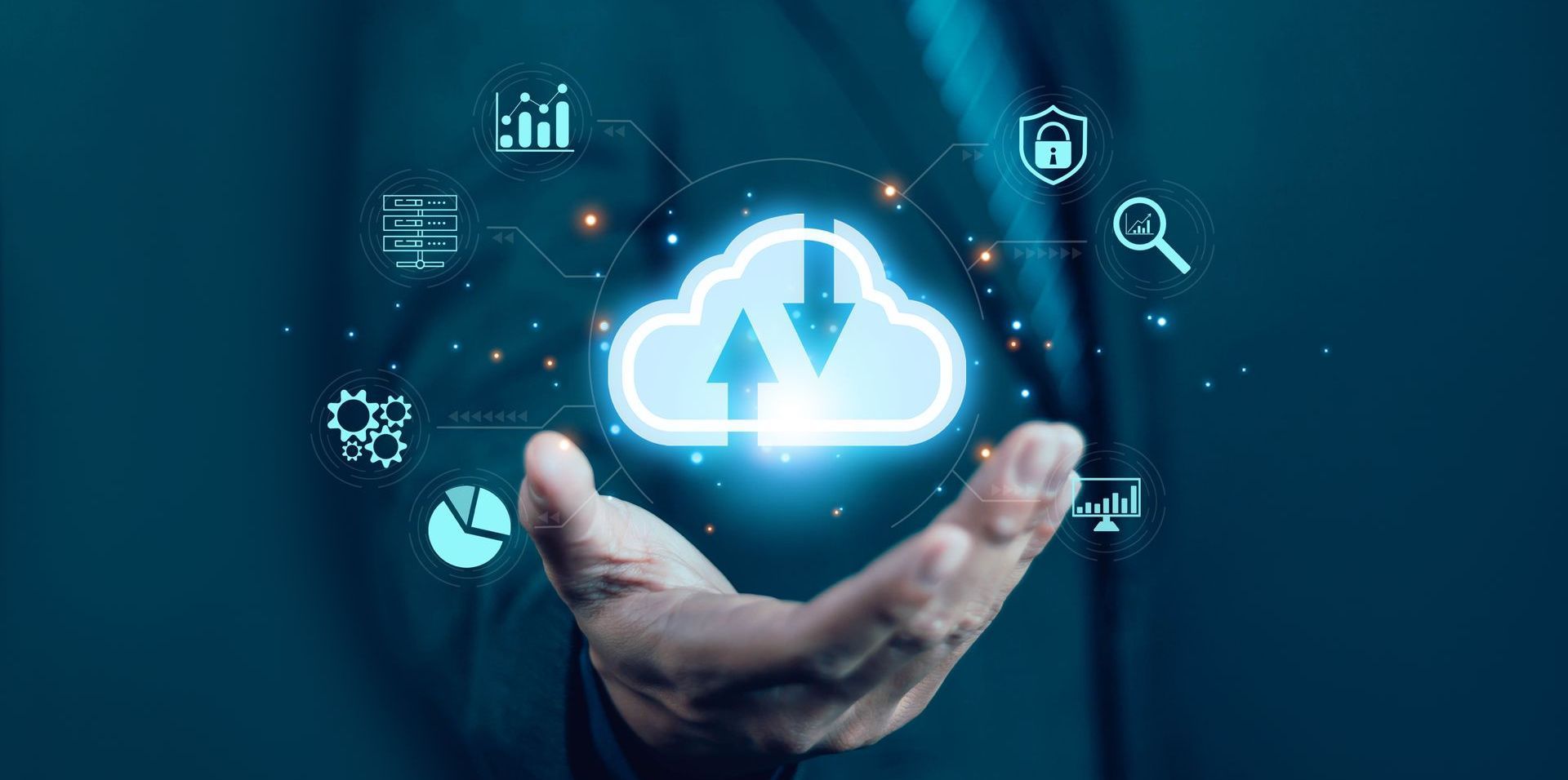 Hand holding a glowing cloud icon surrounded by digital elements, representing cloud computing and data storage.