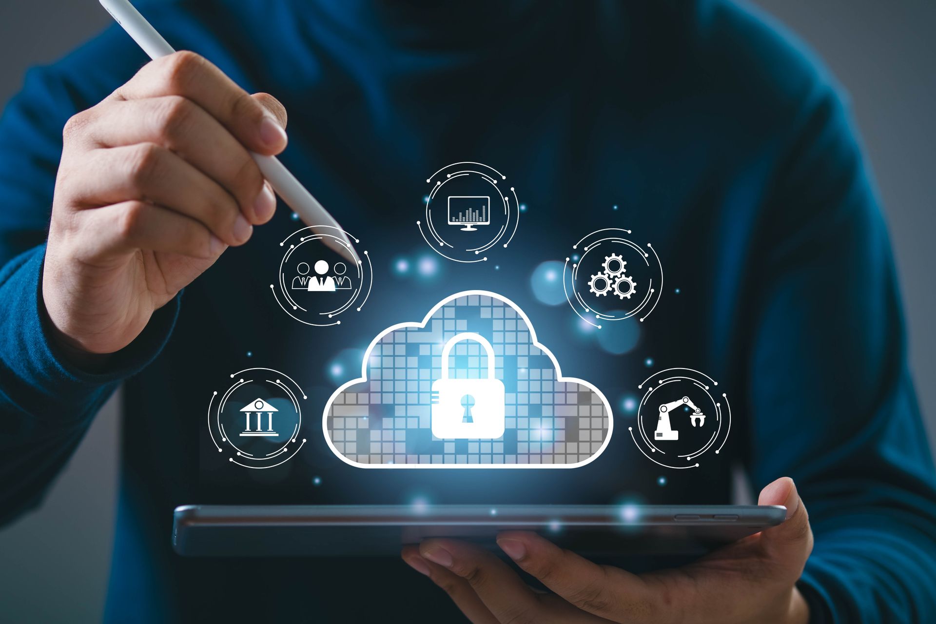 Person using a stylus to interact with a digital cloud with a padlock, surrounded by icons.