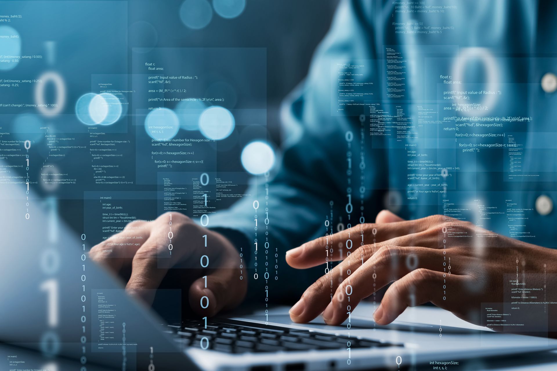 Person typing on a laptop with code overlay in blue tones.